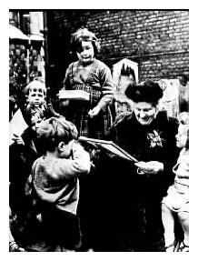 Woman reading to children outside in black and white.